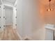 Hallway with hardwood floors, white walls, and modern lighting at 555 N Oakland Ave, Indianapolis, IN 46201