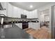 Bright kitchen with stainless steel appliances, dark countertops, and white cabinetry at 555 N Oakland Ave, Indianapolis, IN 46201