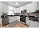 Bright kitchen featuring modern appliances, sleek countertops, and ample cabinet space at 555 N Oakland Ave, Indianapolis, IN 46201