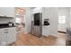Well-lit kitchen with stainless steel refrigerator, modern cabinetry, and open access to the living room at 555 N Oakland Ave, Indianapolis, IN 46201