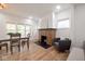 Bright living room featuring hardwood floors, a fireplace, and lots of windows at 555 N Oakland Ave, Indianapolis, IN 46201