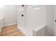 Close up of modern stand up shower featuring bright white subway tile and a black shower head at 555 N Oakland Ave, Indianapolis, IN 46201
