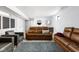 Spacious finished basement with leather seating area, and stylish bar setup at 5678 N College Ave, Indianapolis, IN 46220