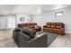 Spacious basement area with modern bar area, light wood flooring, and comfortable seating at 5678 N College Ave, Indianapolis, IN 46220