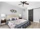 Nautical themed bedroom with ceiling fan, decorative headboard, and sliding barn door to the ensuite at 5678 N College Ave, Indianapolis, IN 46220