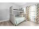 bedroom featuring bunk beds, wood floor, natural light, and colorful patterned curtains at 5678 N College Ave, Indianapolis, IN 46220