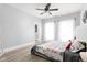 Bright bedroom featuring neutral walls, a decorative quilt, and natural light from large windows at 5678 N College Ave, Indianapolis, IN 46220
