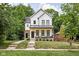 Charming two-story home with a welcoming front porch and a well-manicured lawn at 5678 N College Ave, Indianapolis, IN 46220