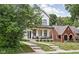 Charming two-story home with inviting front porch and manicured lawn at 5678 N College Ave, Indianapolis, IN 46220