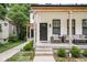 Inviting covered porch featuring comfortable seating and stylish outdoor decor at 5678 N College Ave, Indianapolis, IN 46220