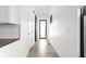 Hallway with white walls, light wood floors, and black framed doors offering a bright, clean aesthetic at 5678 N College Ave, Indianapolis, IN 46220