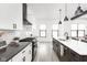 Bright modern kitchen with white cabinets, dark countertops, stainless steel appliances, and a central island at 5678 N College Ave, Indianapolis, IN 46220