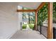 Covered porch featuring wood beam accents and black metal railing at 5678 N College Ave, Indianapolis, IN 46220