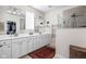 Bright bathroom features double sink vanity, glass shower, and linen closet at 5832 Buskirk Dr, Indianapolis, IN 46216