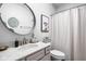 Updated half bath with large mirror and elegant vanity at 5832 Buskirk Dr, Indianapolis, IN 46216