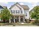 Charming two-story home with a welcoming front porch and beautifully landscaped front yard at 5832 Buskirk Dr, Indianapolis, IN 46216
