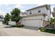 Home's exterior shows a two-car garage with an extended driveway and manicured landscaping at 5832 Buskirk Dr, Indianapolis, IN 46216
