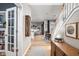 Inviting hallway with hardwood floors that leads to an open-concept living and dining area at 5832 Buskirk Dr, Indianapolis, IN 46216
