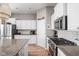 Modern kitchen featuring stainless steel appliances, granite countertops, and white cabinets at 5832 Buskirk Dr, Indianapolis, IN 46216