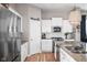 Bright kitchen featuring white cabinets, granite countertops, and stainless steel appliances at 5832 Buskirk Dr, Indianapolis, IN 46216