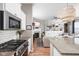 Open concept kitchen with granite counters, stainless appliances and view to the living room and fireplace at 5832 Buskirk Dr, Indianapolis, IN 46216