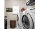 Laundry room with front load washer and dryer and additional storage at 5832 Buskirk Dr, Indianapolis, IN 46216