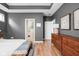 Spacious main bedroom with a tray ceiling, hardwood floors, and natural light at 5832 Buskirk Dr, Indianapolis, IN 46216