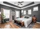 Comfortable main bedroom with a ceiling fan, hardwood floors, and soft natural light at 5832 Buskirk Dr, Indianapolis, IN 46216