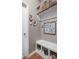 Mud room has bench with storage, hooks, and art at 5832 Buskirk Dr, Indianapolis, IN 46216