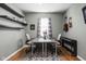 Home office with hardwood floors, guitar, and shelves at 5832 Buskirk Dr, Indianapolis, IN 46216