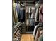 Organized walk-in closet featuring custom shelving, hanging rods and hardwood floor at 5832 Buskirk Dr, Indianapolis, IN 46216