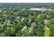 Aerial view of neighborhood showcasing a home with a red star marker surrounded by trees at 6019 S Tacoma Ave, Indianapolis, IN 46227