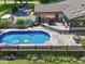 Aerial view of a sparkling pool, deck, dining area, and a well-maintained yard, ideal for outdoor activities at 6019 S Tacoma Ave, Indianapolis, IN 46227