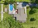 Aerial view of a home with a well-maintained yard, inground pool and patio area at 6019 S Tacoma Ave, Indianapolis, IN 46227