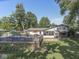 Expansive backyard featuring a refreshing in-ground pool, spacious deck, and a well-manicured lawn at 6019 S Tacoma Ave, Indianapolis, IN 46227