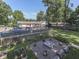 Lush backyard featuring an in-ground pool with a deck, a charming fire pit area, and garden beds at 6019 S Tacoma Ave, Indianapolis, IN 46227
