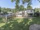 Charming backyard with an inviting in-ground pool, deck, enclosed patio and beautifully maintained lawn and landscaping at 6019 S Tacoma Ave, Indianapolis, IN 46227