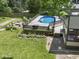 Inviting backyard features a sparkling in-ground pool with a spacious deck, firepit, and lovely landscaping at 6019 S Tacoma Ave, Indianapolis, IN 46227