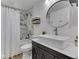 Modern bathroom featuring a sleek rectangular sink, round mirror, and marble-tiled shower for a contemporary look at 6019 S Tacoma Ave, Indianapolis, IN 46227