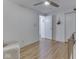 Bright Bedroom featuring hardwood floors, a ceiling fan, and a glimpse into another room via an open door at 6019 S Tacoma Ave, Indianapolis, IN 46227