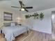 Comfortable bedroom featuring hardwood floors, ceiling fan, and natural light at 6019 S Tacoma Ave, Indianapolis, IN 46227