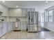 Well-lit kitchen features stainless steel appliances, gray cabinetry, and granite countertops at 6019 S Tacoma Ave, Indianapolis, IN 46227