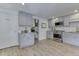 Modern kitchen featuring gray cabinets, granite countertops, stainless steel appliances, and pantry access at 6019 S Tacoma Ave, Indianapolis, IN 46227