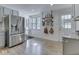 Bright kitchen boasts stainless steel refrigerator, wood floors, and decorative shelving at 6019 S Tacoma Ave, Indianapolis, IN 46227