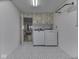 Well-lit laundry room with modern washer and dryer, cabinets, and stylish flooring for added appeal at 6019 S Tacoma Ave, Indianapolis, IN 46227