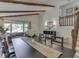 Bright living room featuring exposed wood beams, large windows, and elegant decor at 6019 S Tacoma Ave, Indianapolis, IN 46227