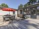 Inviting patio area with stone flooring, a dining table, a grill, and exterior access, perfect for outdoor entertaining at 6019 S Tacoma Ave, Indianapolis, IN 46227
