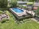 Outdoor pool surrounded by a wooden deck and lush landscaping in a private backyard at 6019 S Tacoma Ave, Indianapolis, IN 46227