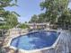 Inviting backyard pool with a wooden deck, basketball hoop, and serene surroundings at 6019 S Tacoma Ave, Indianapolis, IN 46227