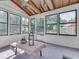 Sunroom featuring beamed ceilings, ample windows, and access to the outdoors at 6019 S Tacoma Ave, Indianapolis, IN 46227